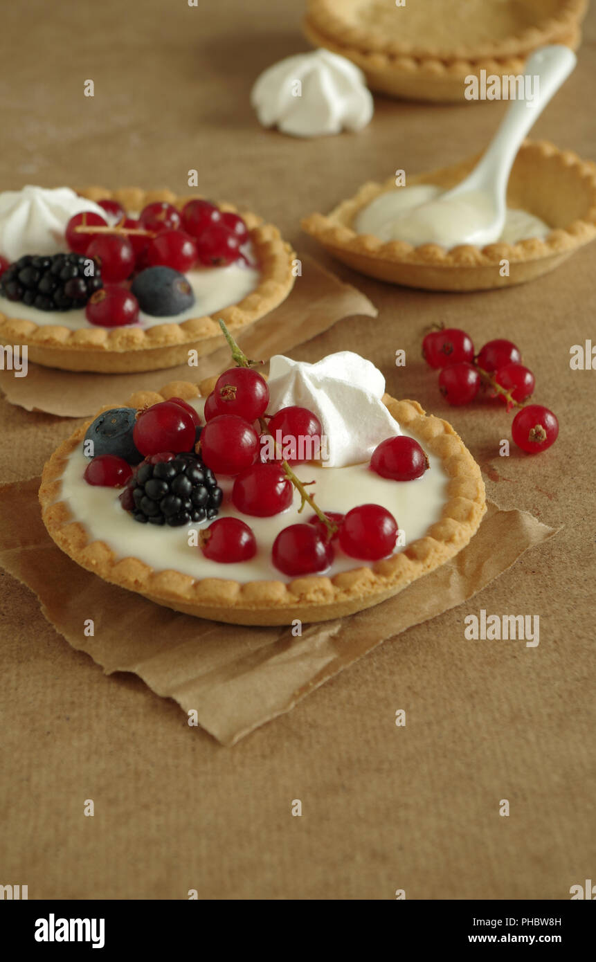 small tartlet with vanilla cream, berries and meringue Stock Photo