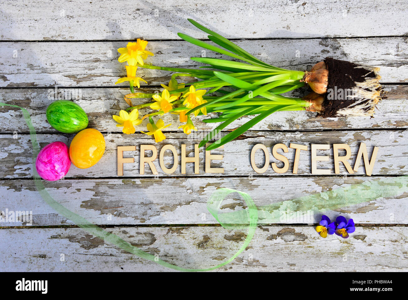 Easter bells and easter eggs on old white wood background Stock Photo