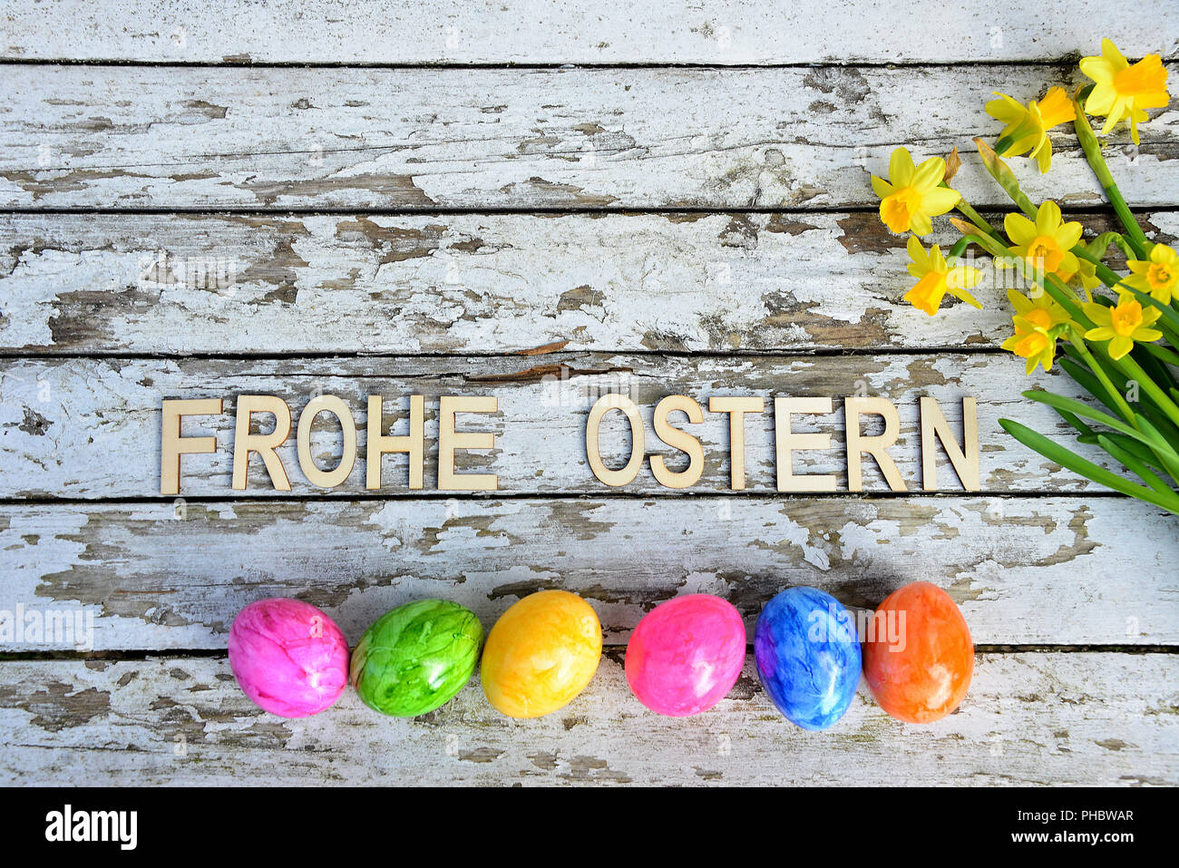 Easter bells and easter eggs on old white wood background Stock Photo