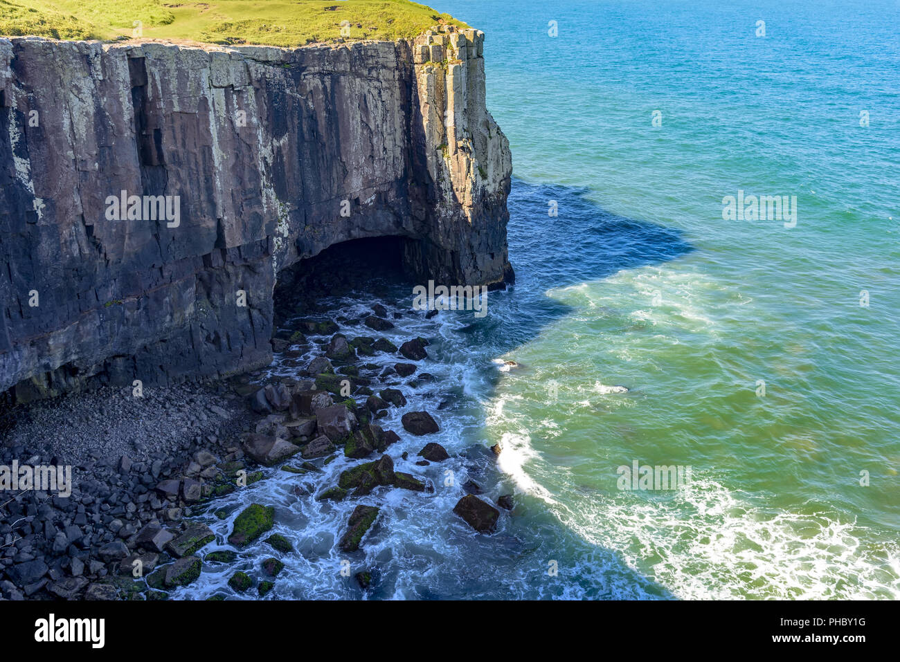 Cliff with cavern over sea Stock Photo