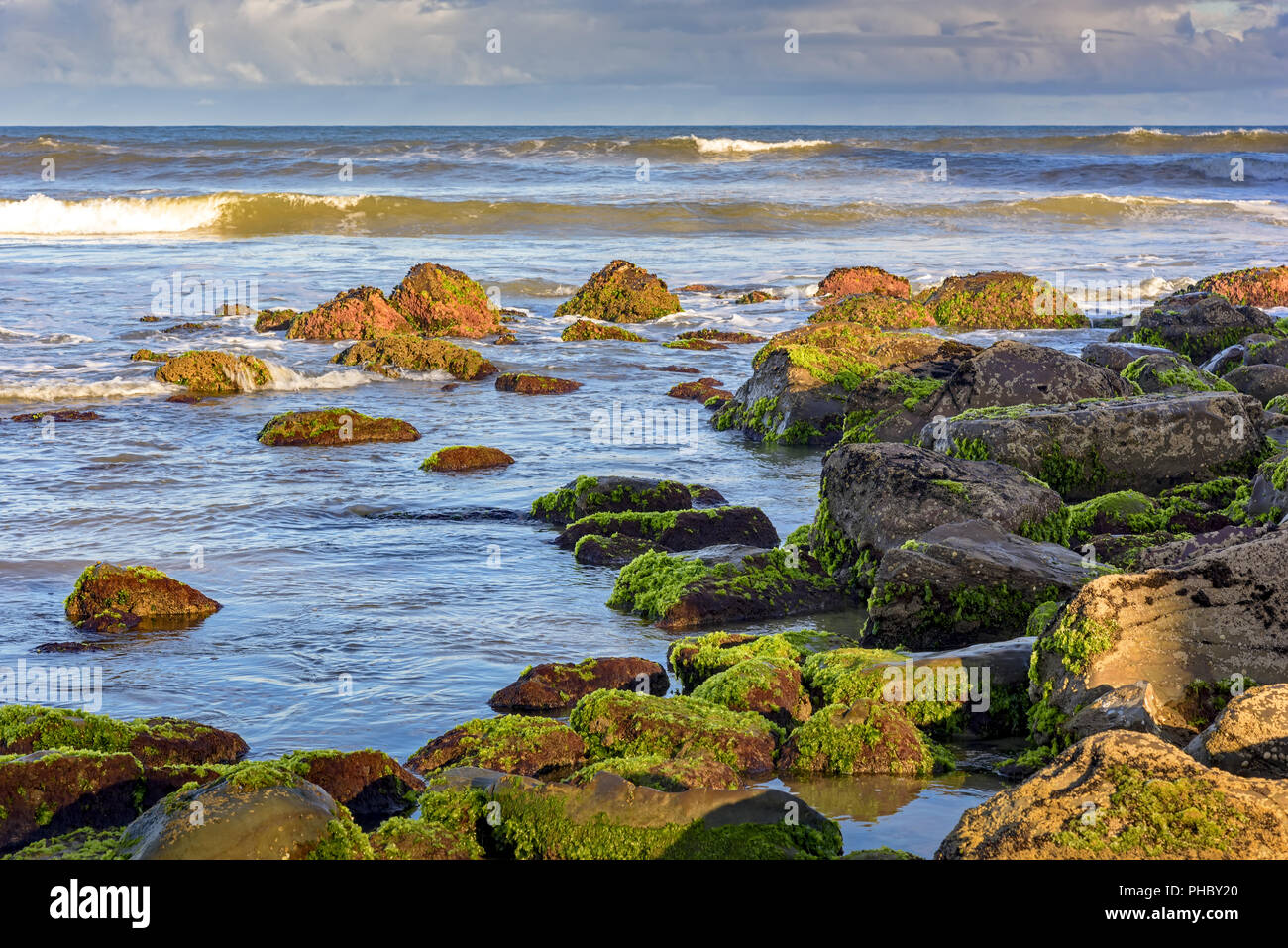 Stones and water with horizon line of Torres city Stock Photo