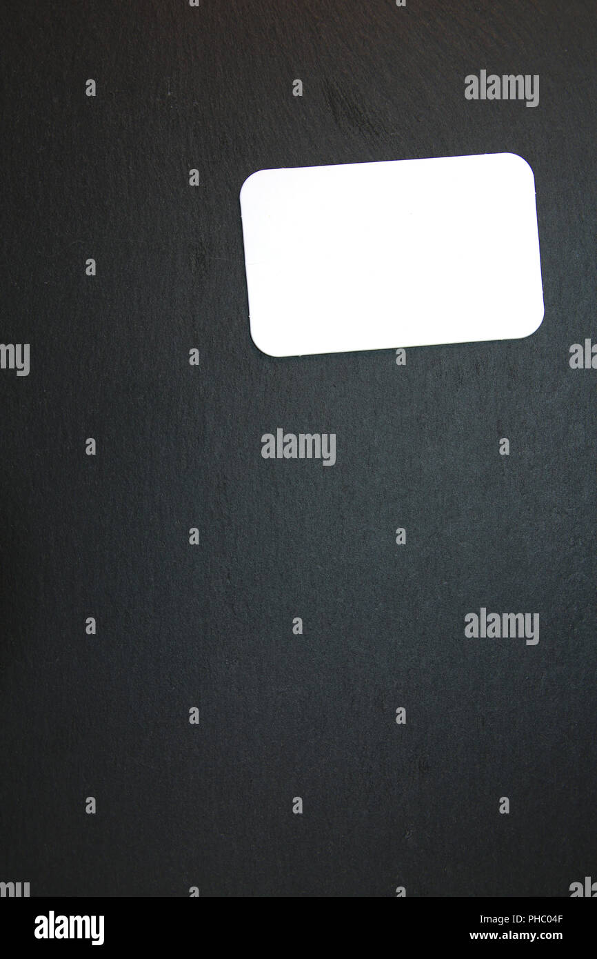 Blackboard with blank notepad Stock Photo