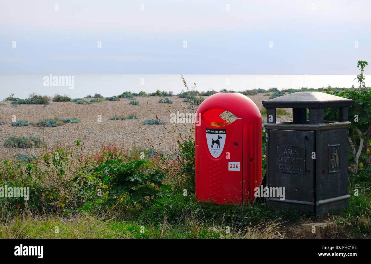 Dog Poo and general litter bins side by side on beach at East Preston, West Sussex Stock Photo