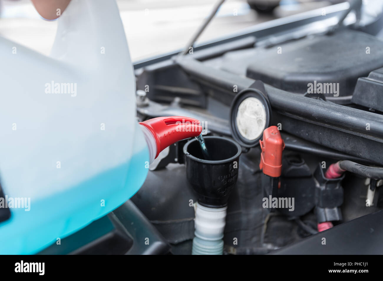 Disk cleaner is refilled with the car - close-up hood Stock Photo