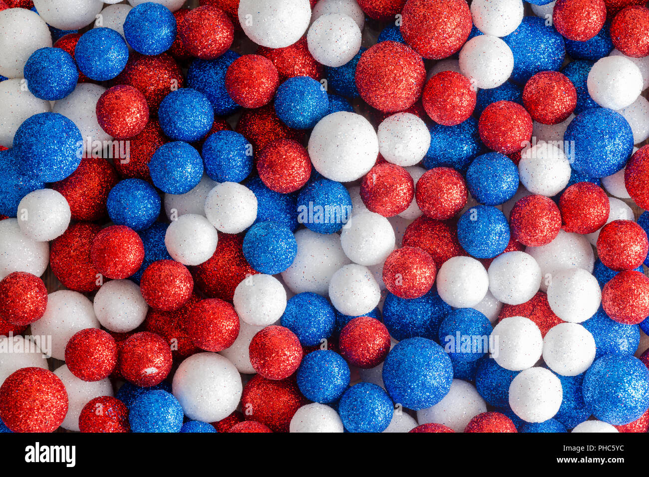 Red white and blue decorative glitter balls in a random mix forming an abstract patriotic American or British background pattern Stock Photo