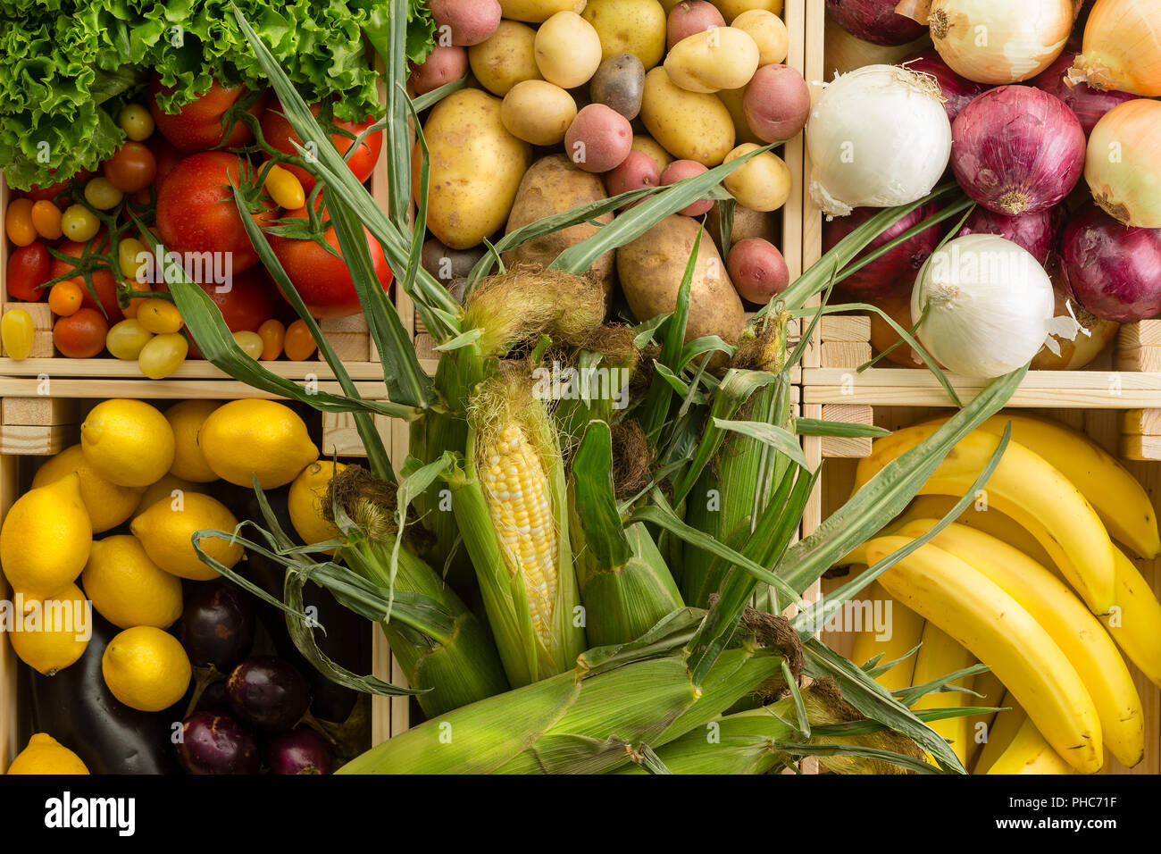 Fresh healthy assorted fruit and vegetables background displayed together in wooden boxes wooden table at an organic farmers market in a full frame cl Stock Photo