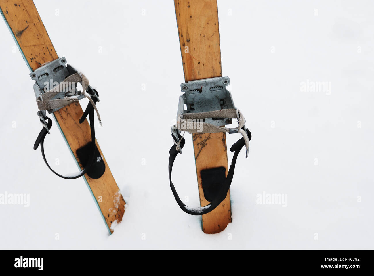old wooden skis in the snow Stock Photo