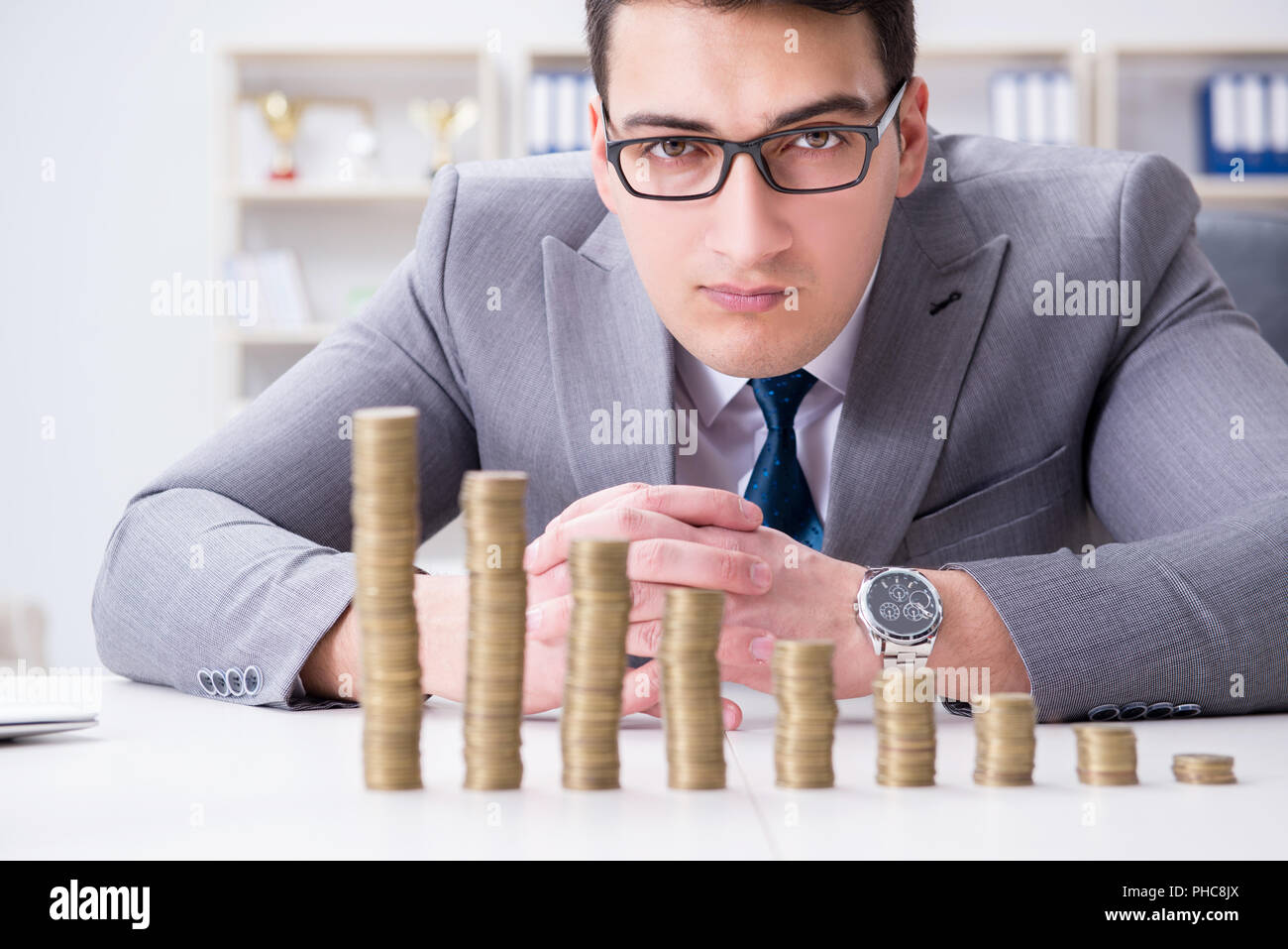 The businessman with golden coins in business growth concept Stock ...