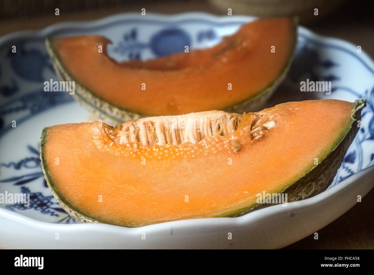 Sliced Cantaloupe melon tn a bowl (Meissen china. onion pattern) Stock Photo