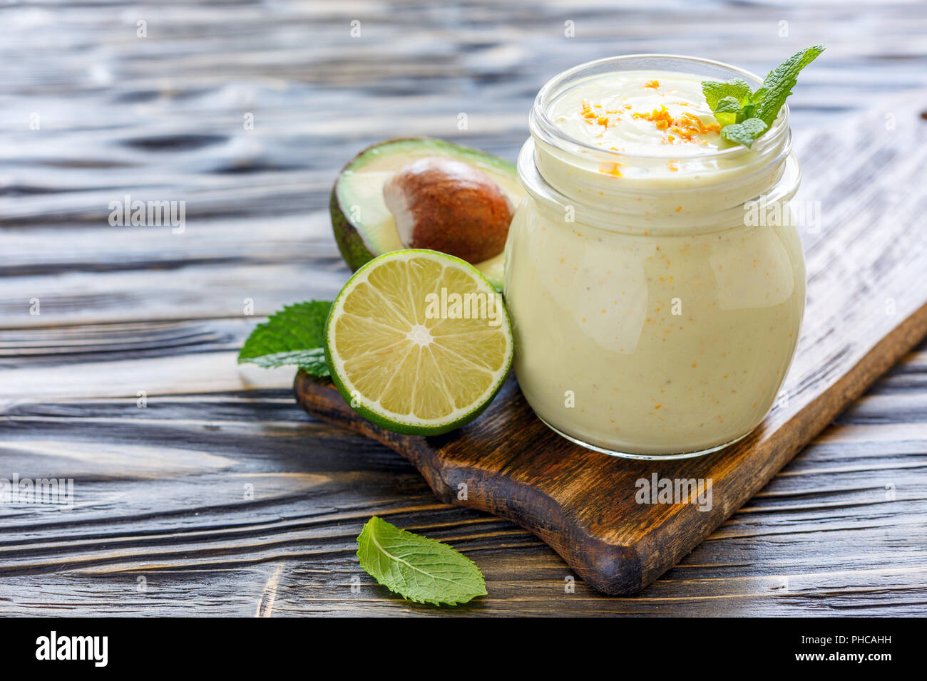 Useful smoothies of avocado in a glass jar. Stock Photo