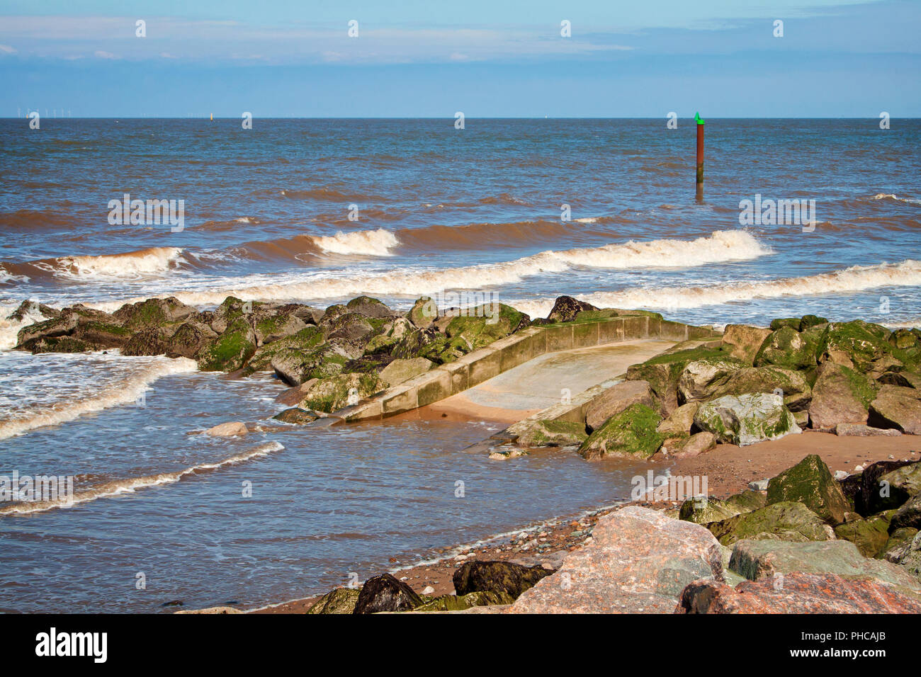 Waves gently lapping the shoreline at Rossall, Fylde Coast, Lancashire, England Stock Photo