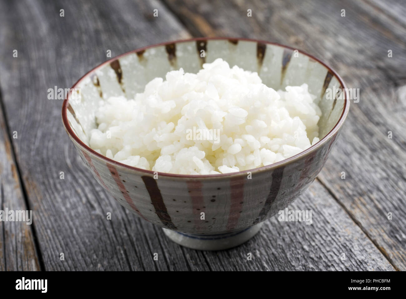 Traditional Japanese Koshihikari Rice as closeup in a bowl Stock Photo