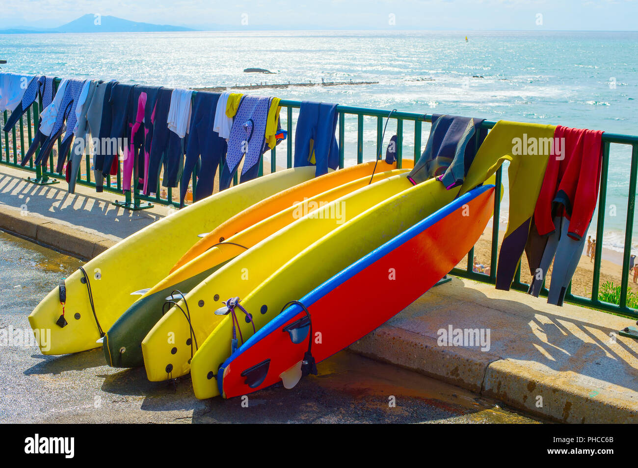 Surfboards And Wetsuits At Beach Stock Photo - Alamy