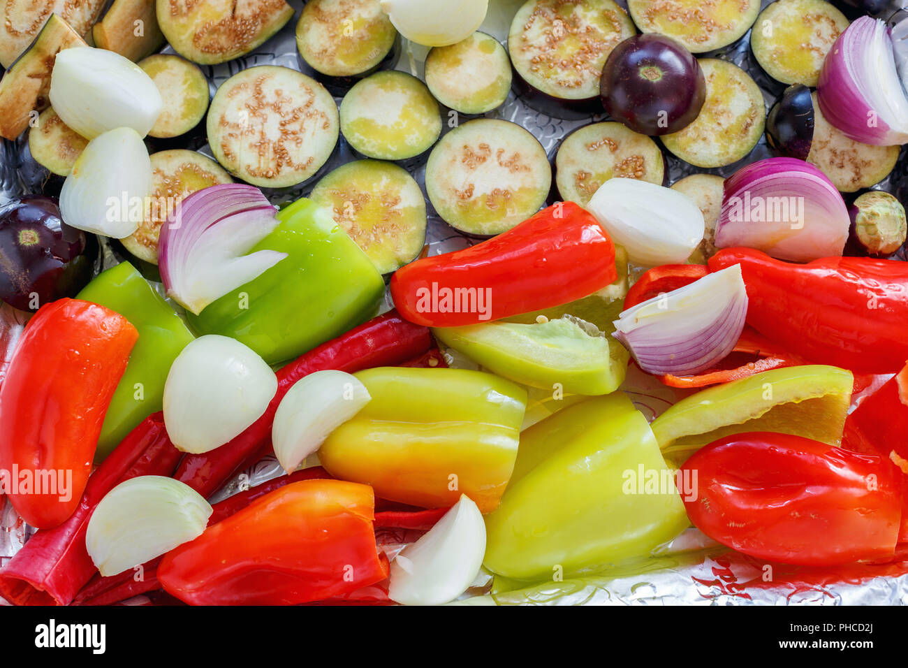 Vegetables are cut into pieces for roasting Stock Photo Alamy