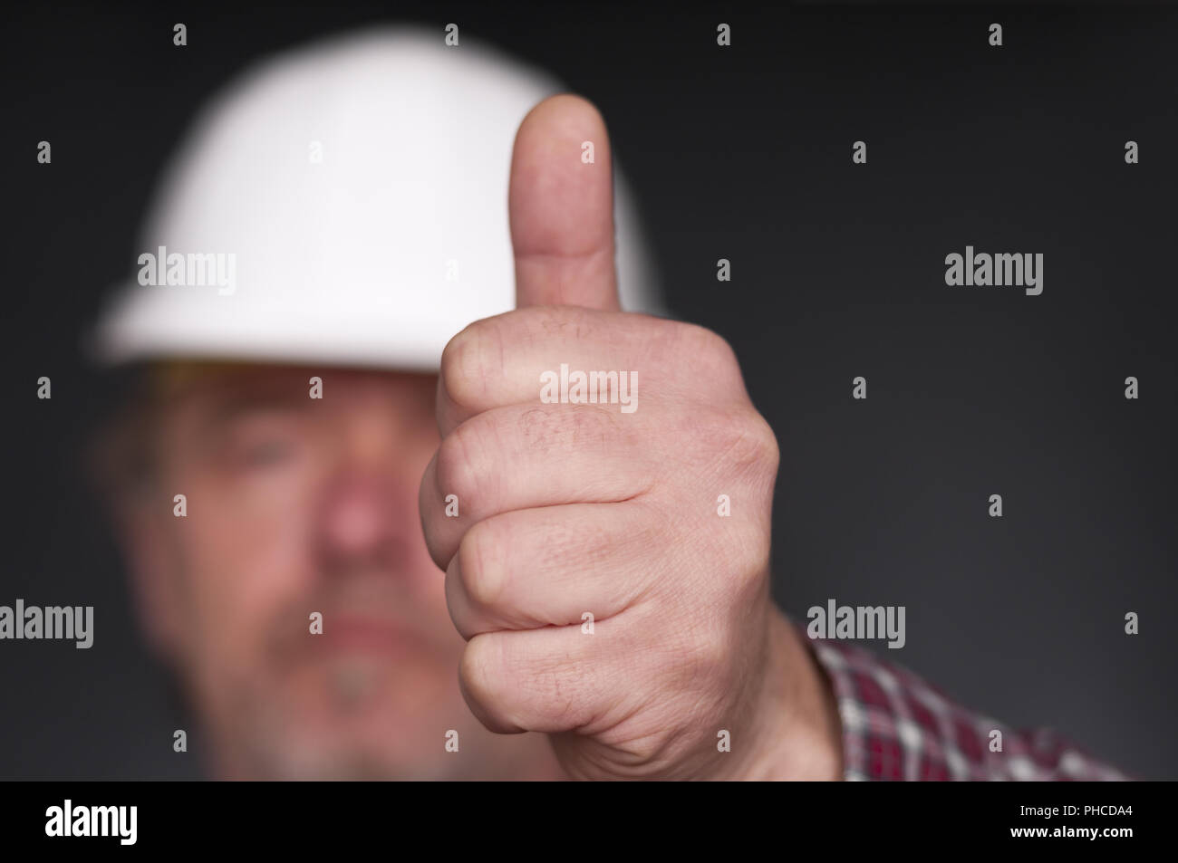 Construction worker showing hand with thumb up Stock Photo