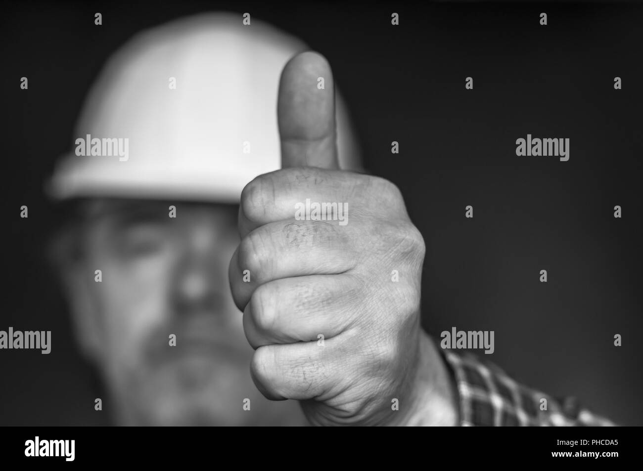 Construction worker showing hand with thumb up Stock Photo