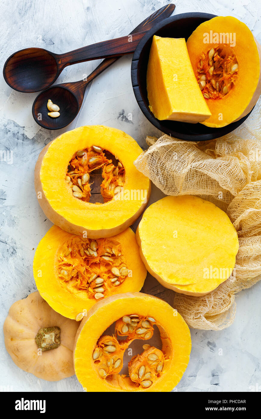 Ripe pumpkin sliced and wooden spoons. Stock Photo