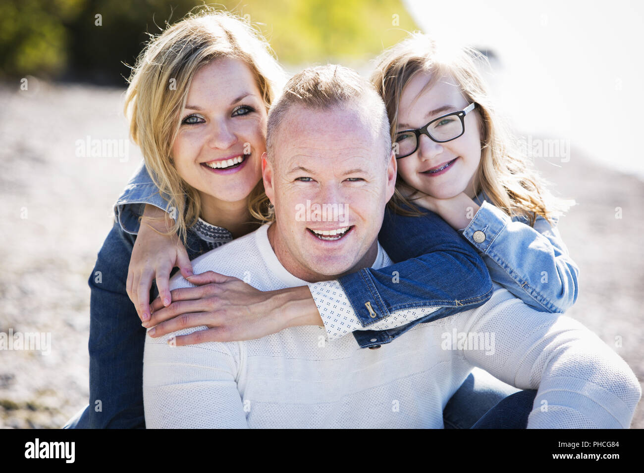 Young family on the beach hi-res stock photography and images - Alamy