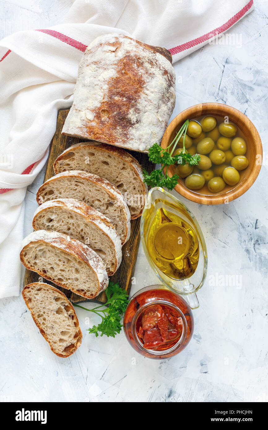 Homemade Italian bread, olives,sundried tomatoes and oil Stock Photo