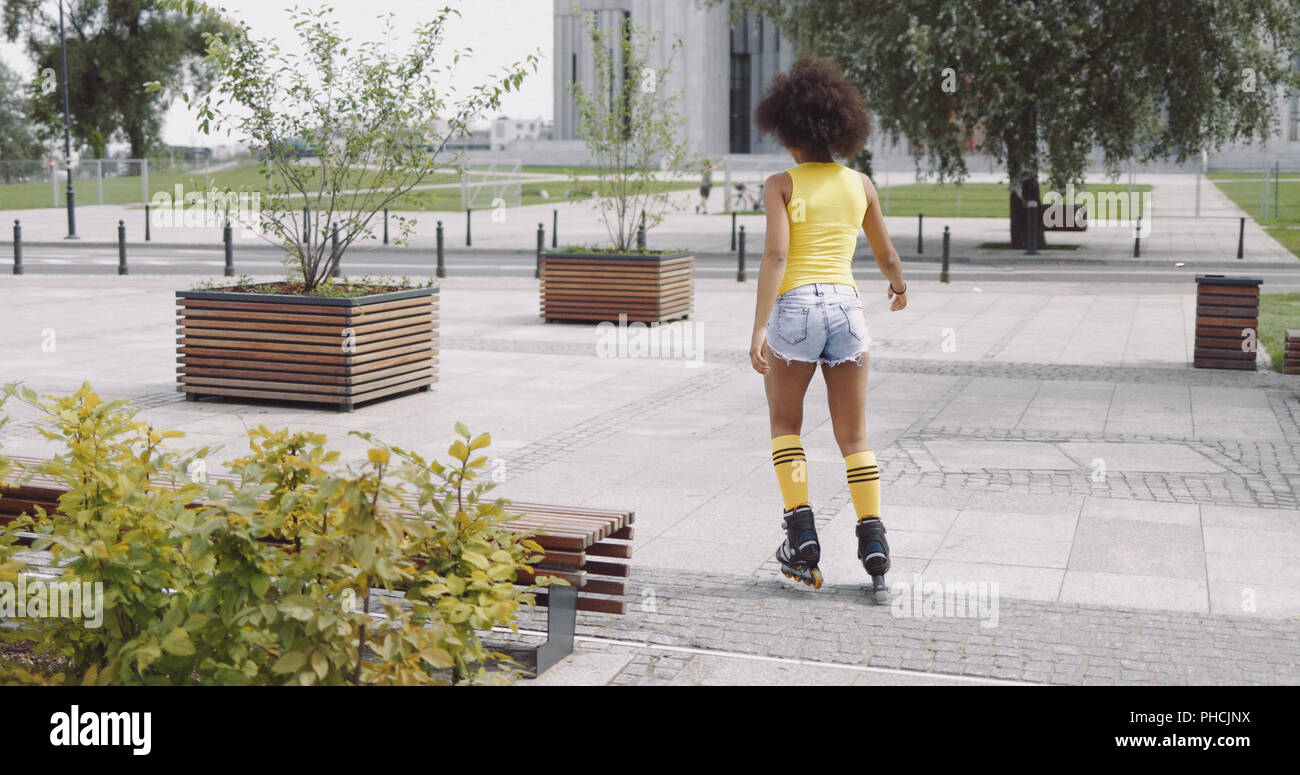 Anonymous woman roller skating in park Stock Photo