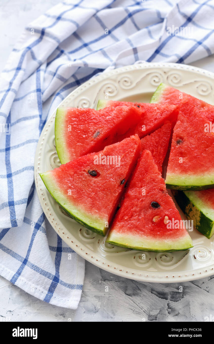 Juicy watermelon sliced on a white porcelain dish. Stock Photo