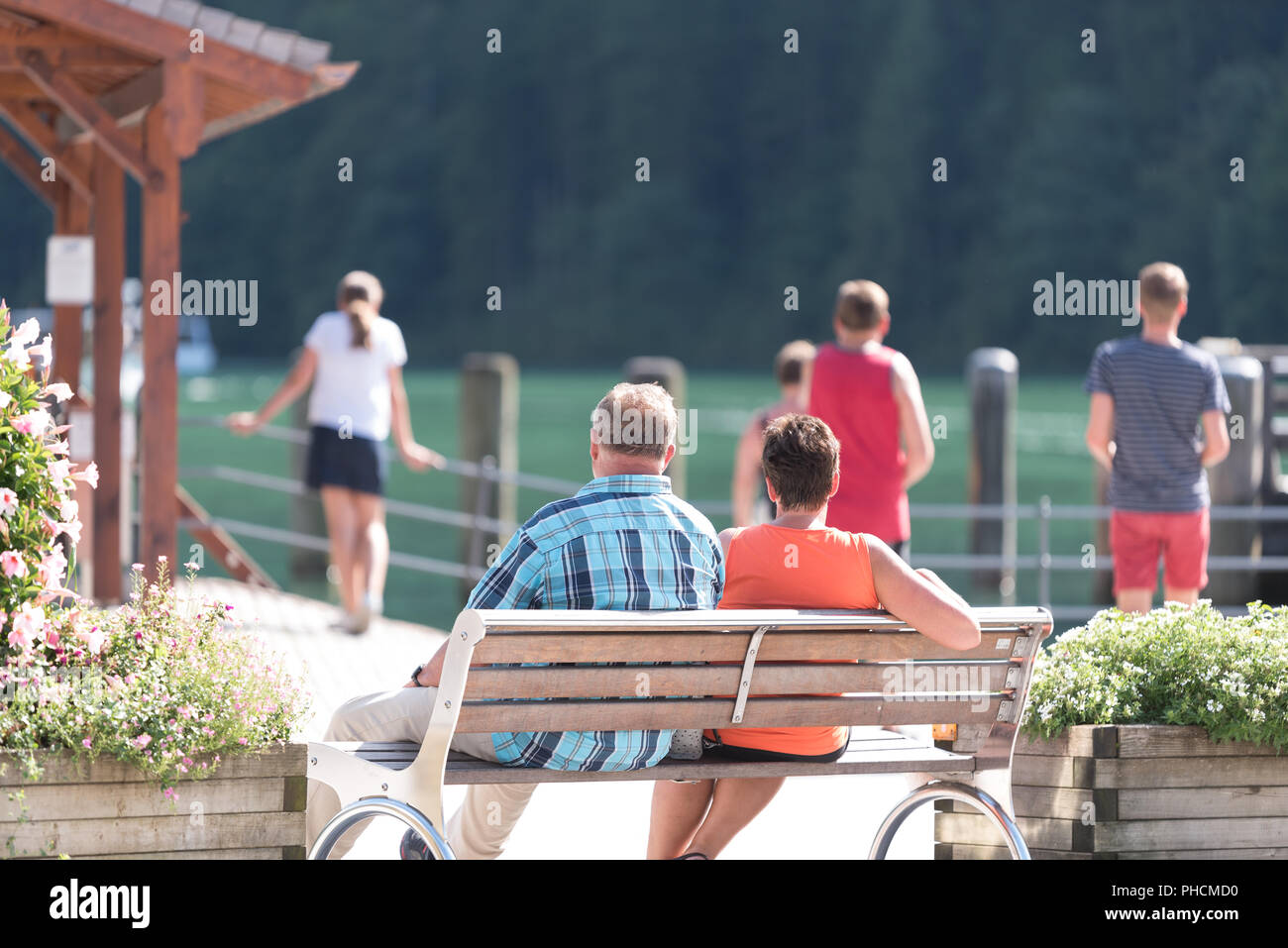 People on holiday look at a lake Stock Photo