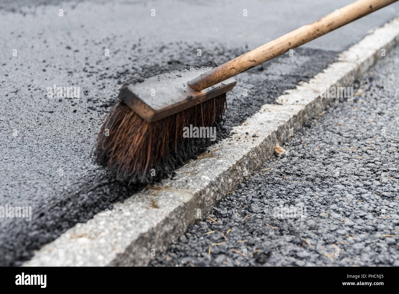 Broom for asphalting works - close-up Stock Photo
