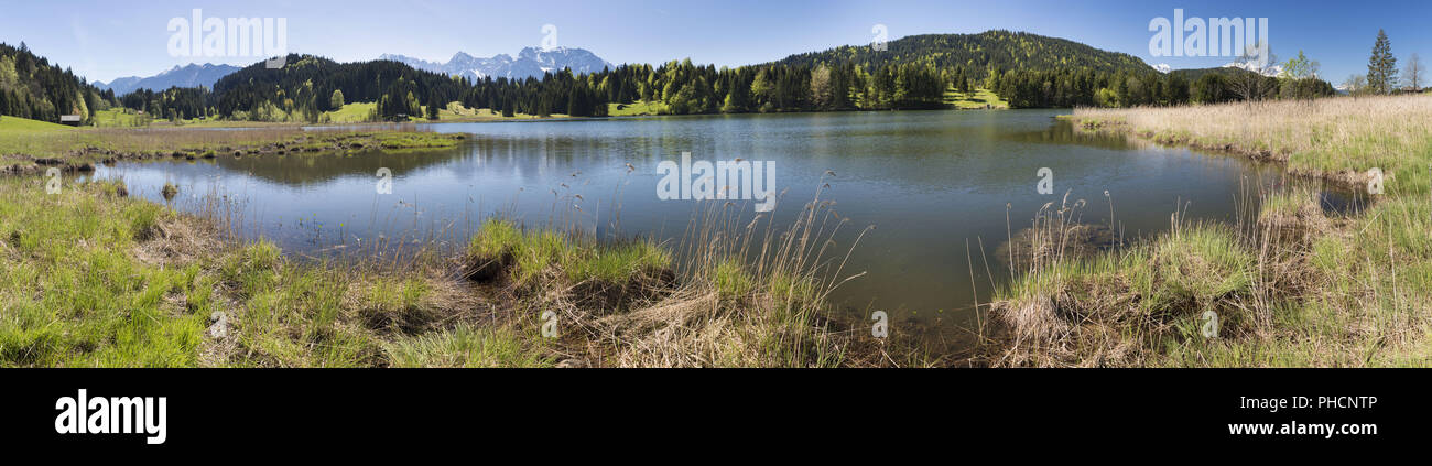 wide angle view to lake in Bavaria with alps mountains Stock Photo