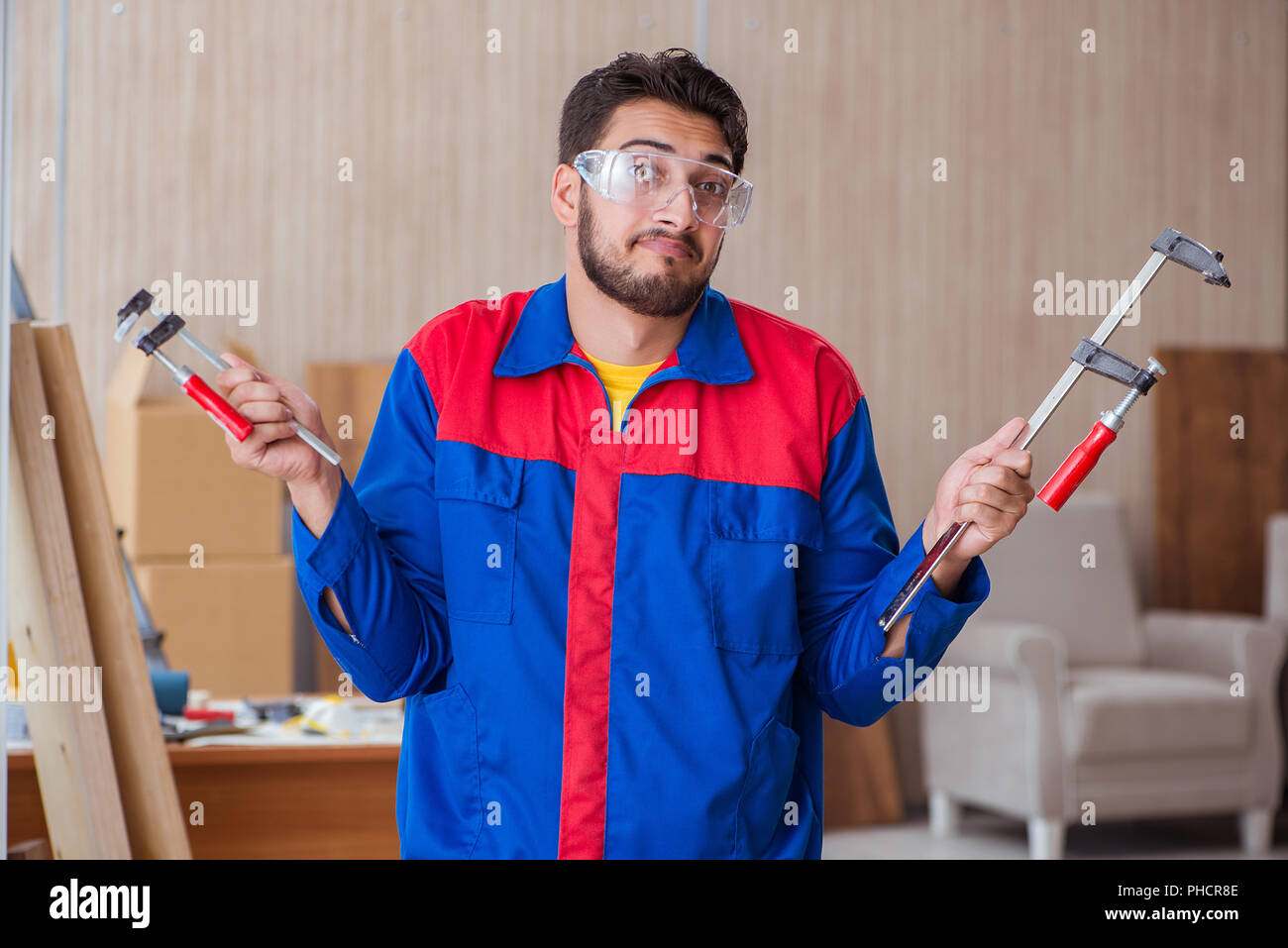 Young repairman carpenter working with clamps Stock Photo