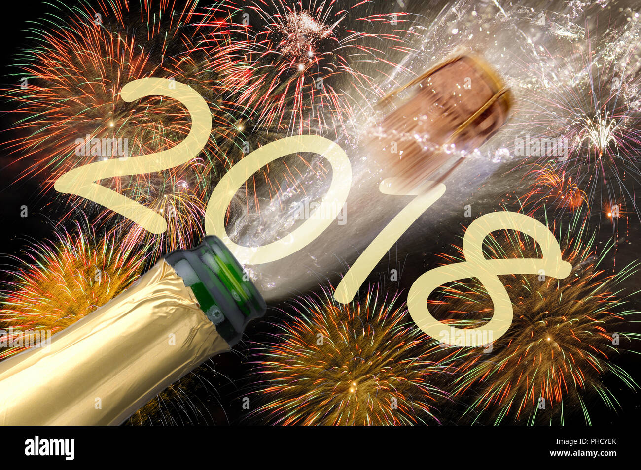 popping cork of champagne with fireworks at new years eve Stock Photo