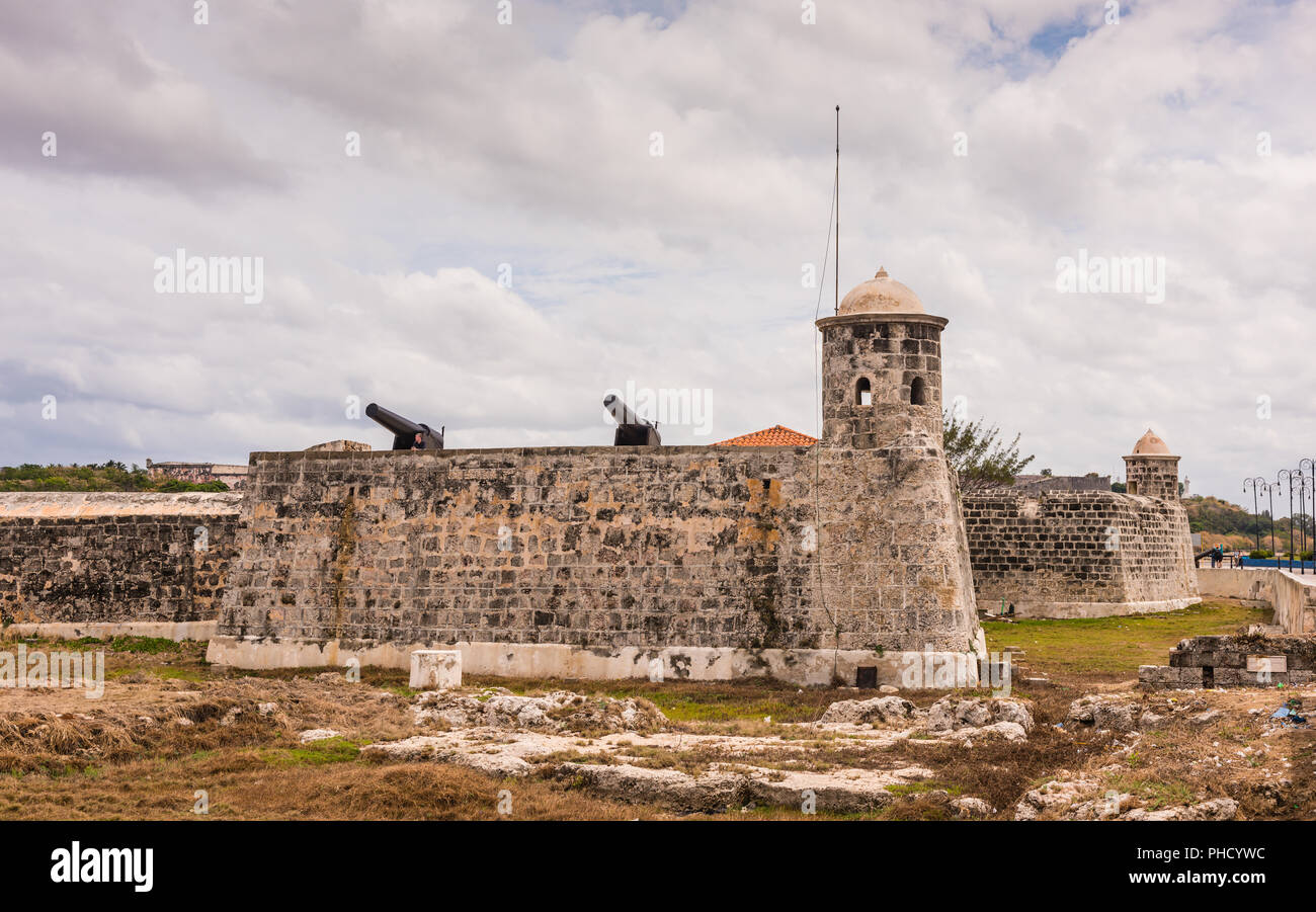 Havana, Cuba / March 22, 2016: Cannons atop wall and lookout towers at Morro Castle  where it historically guards Havana Bay. Stock Photo