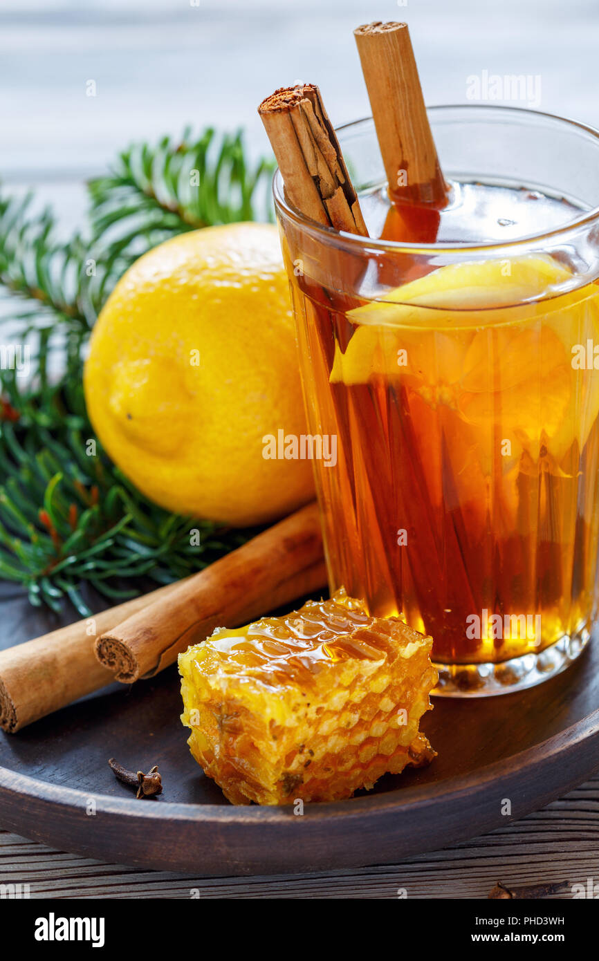 Spicy lemon tea, cinnamon sticks,cloves and honey Stock Photo Alamy