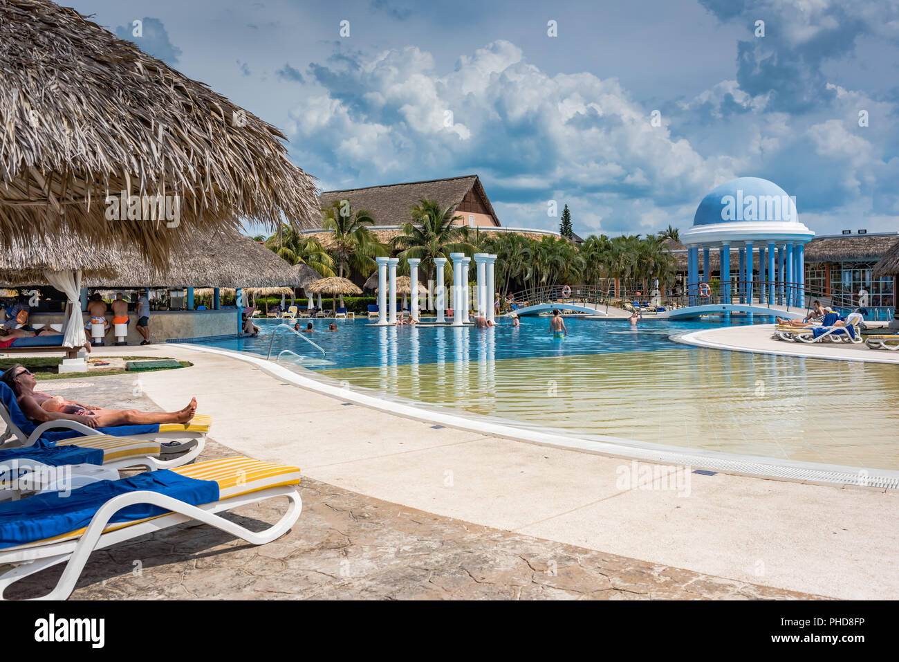 Varadero, Cuba / March 19, 2016:, 2016: Guests playing in and relaxing by the resort pool. Stock Photo