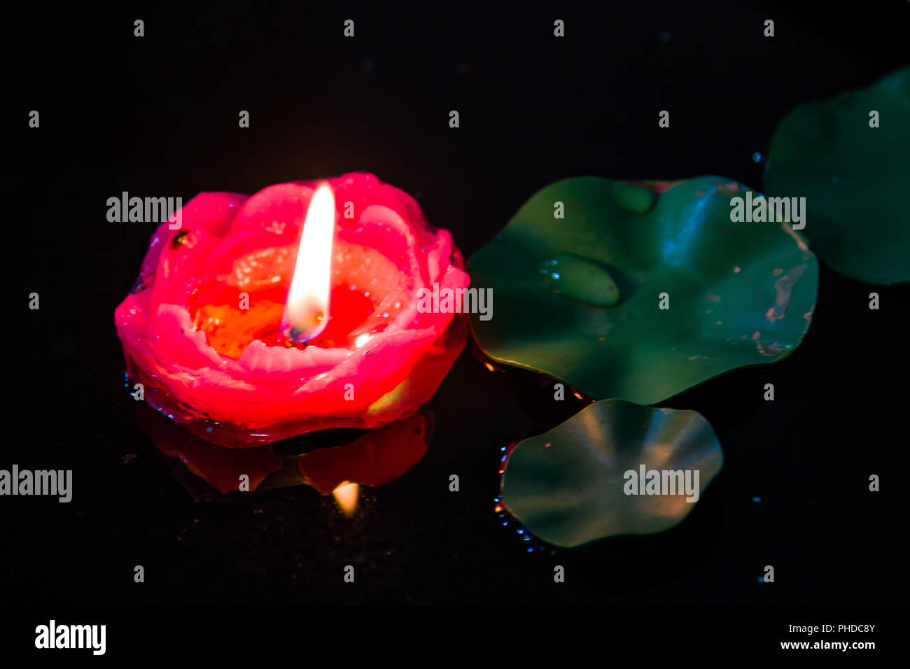 Floating red candle in a pond Stock Photo Alamy