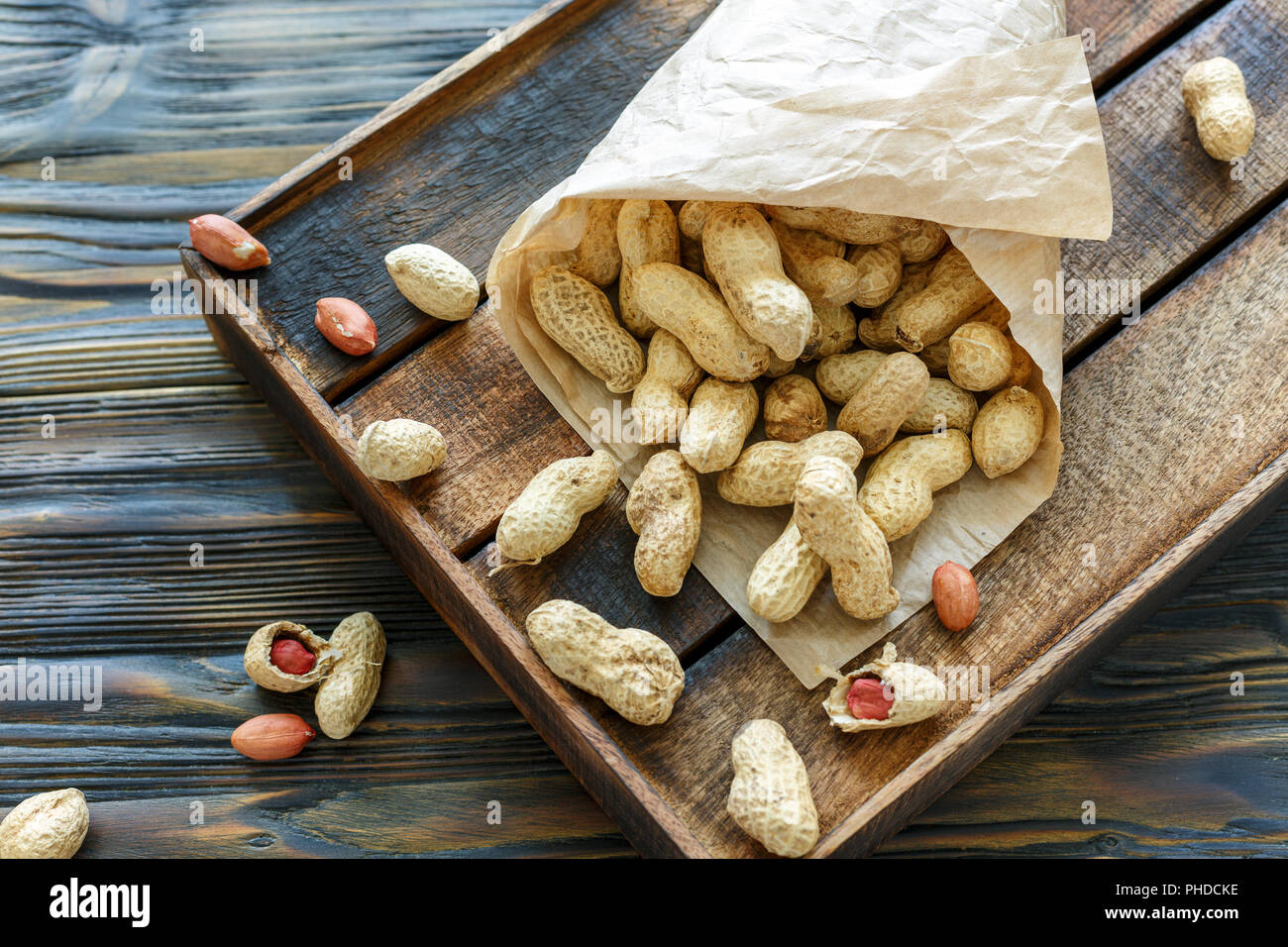 Paper bag with unshelled peanuts. Stock Photo