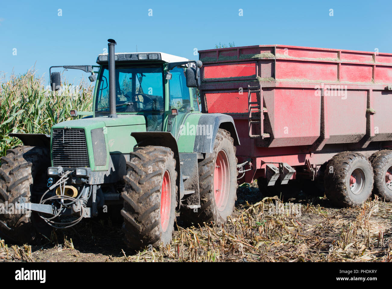Corn harvest, harvest truck with tractor Stock Photo Alamy