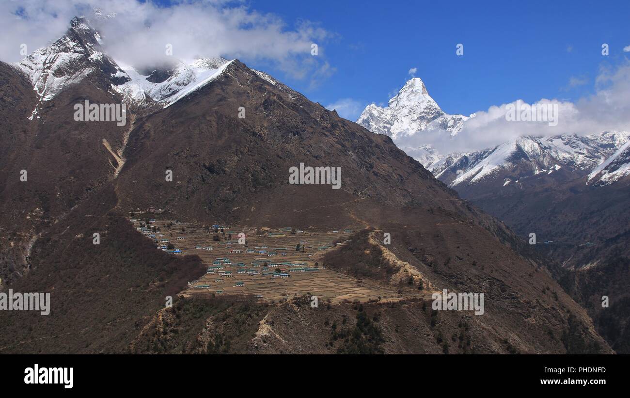 Sherpa village Phortse and snow covered mount Ama Dablam. Stock Photo