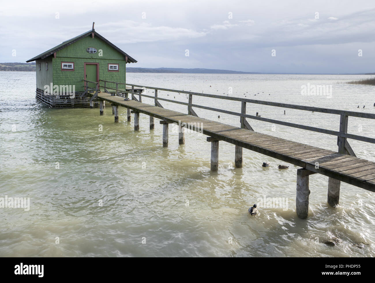 Old wooden pier and hut at lake Ammersee in Germany Stock Photo