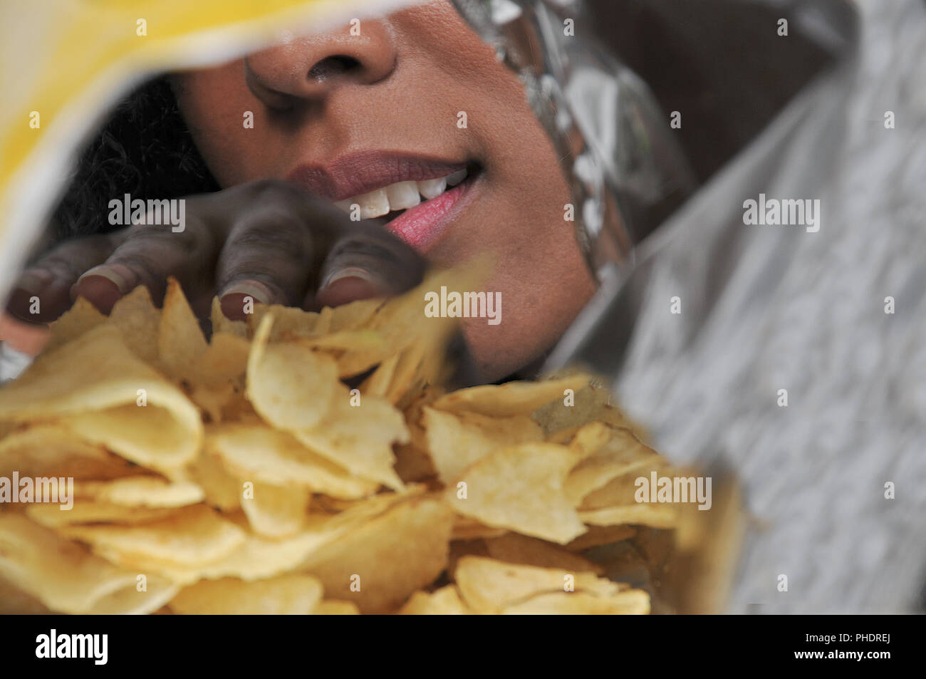 Woman eating potato chips Stock Photo Alamy