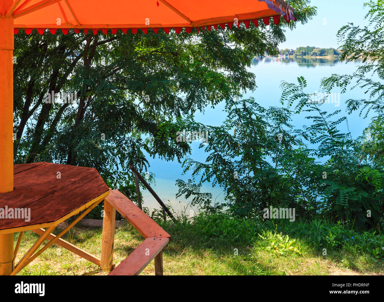 Сamping pitch on summer lake calm beach Stock Photo