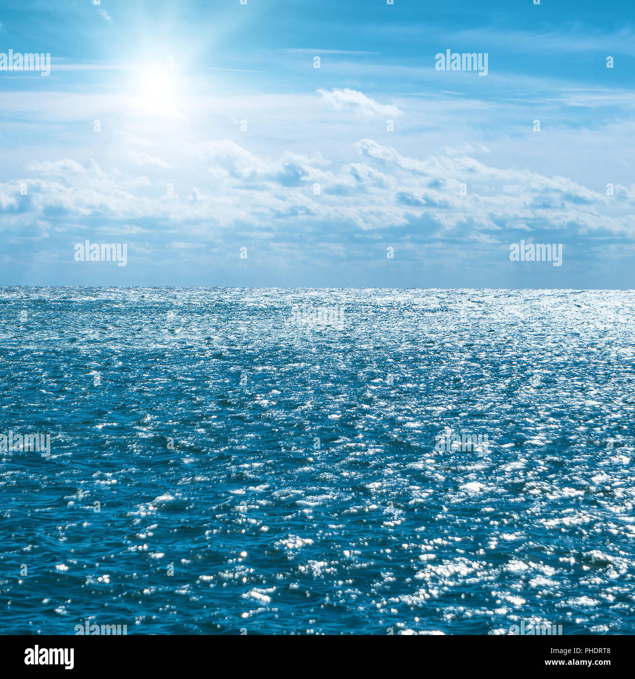 Blue sea with sky and clouds Stock Photo - Alamy