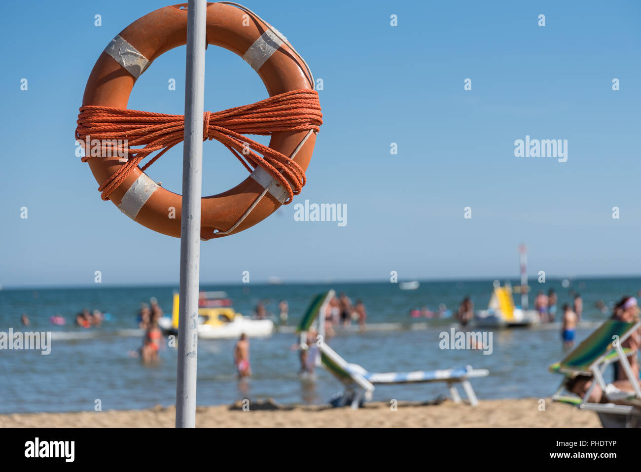 Lifebuoy on the sandy beach and sea view Stock Photo