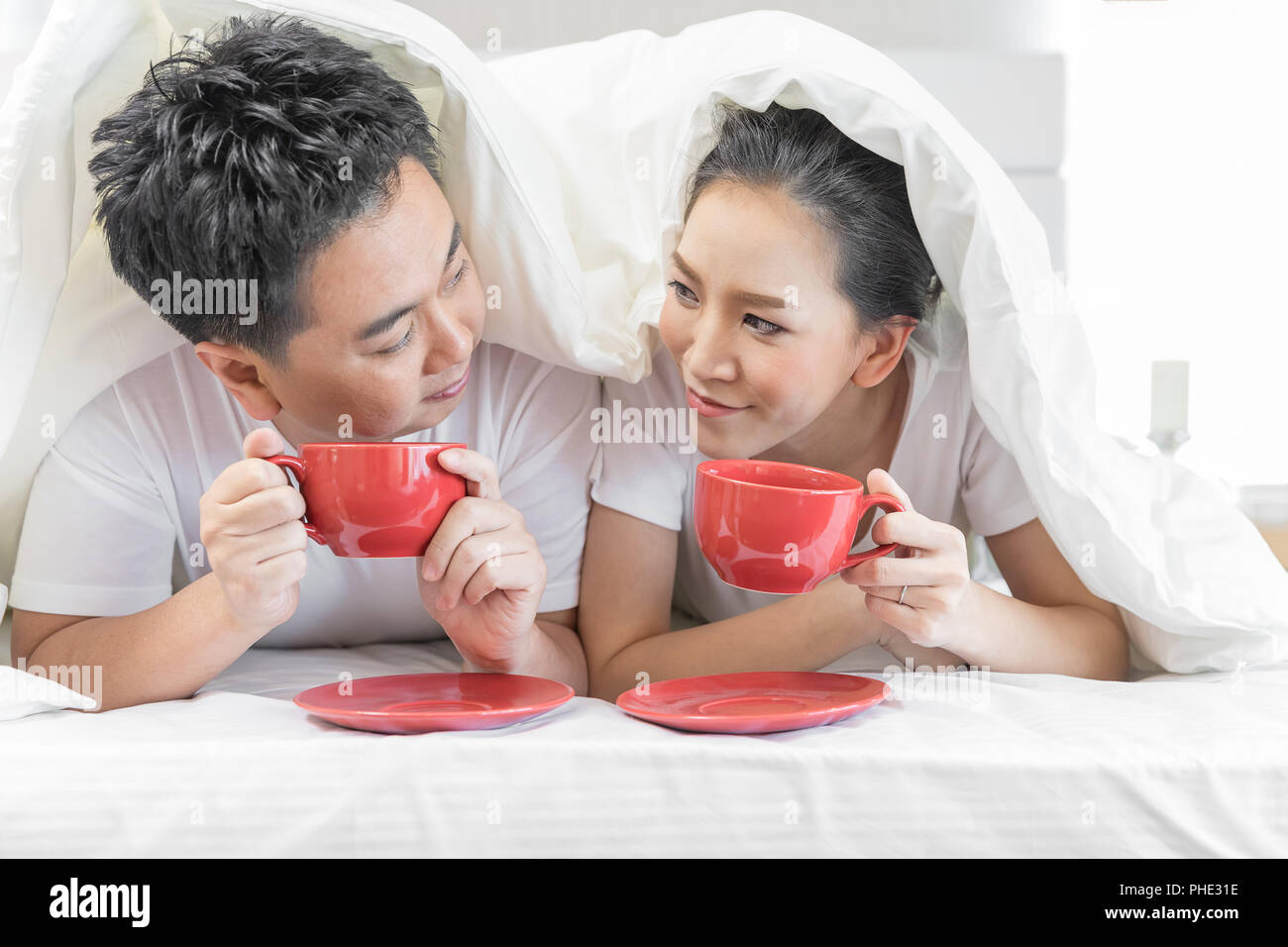 Couples having breakfast on bed Stock Photo Alamy