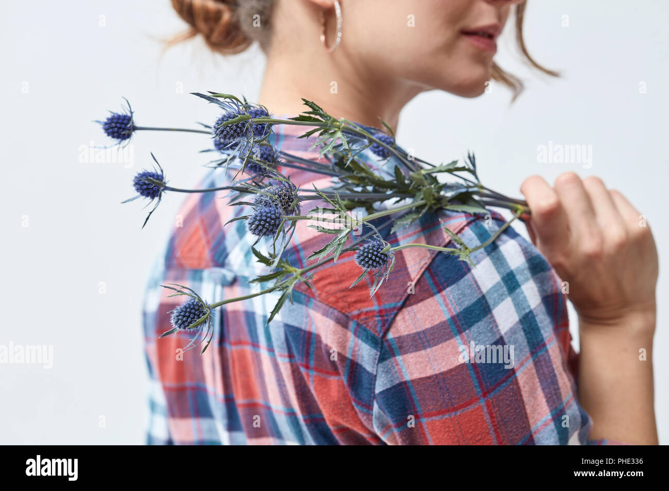 Young girl with flowers eryngium Stock Photo