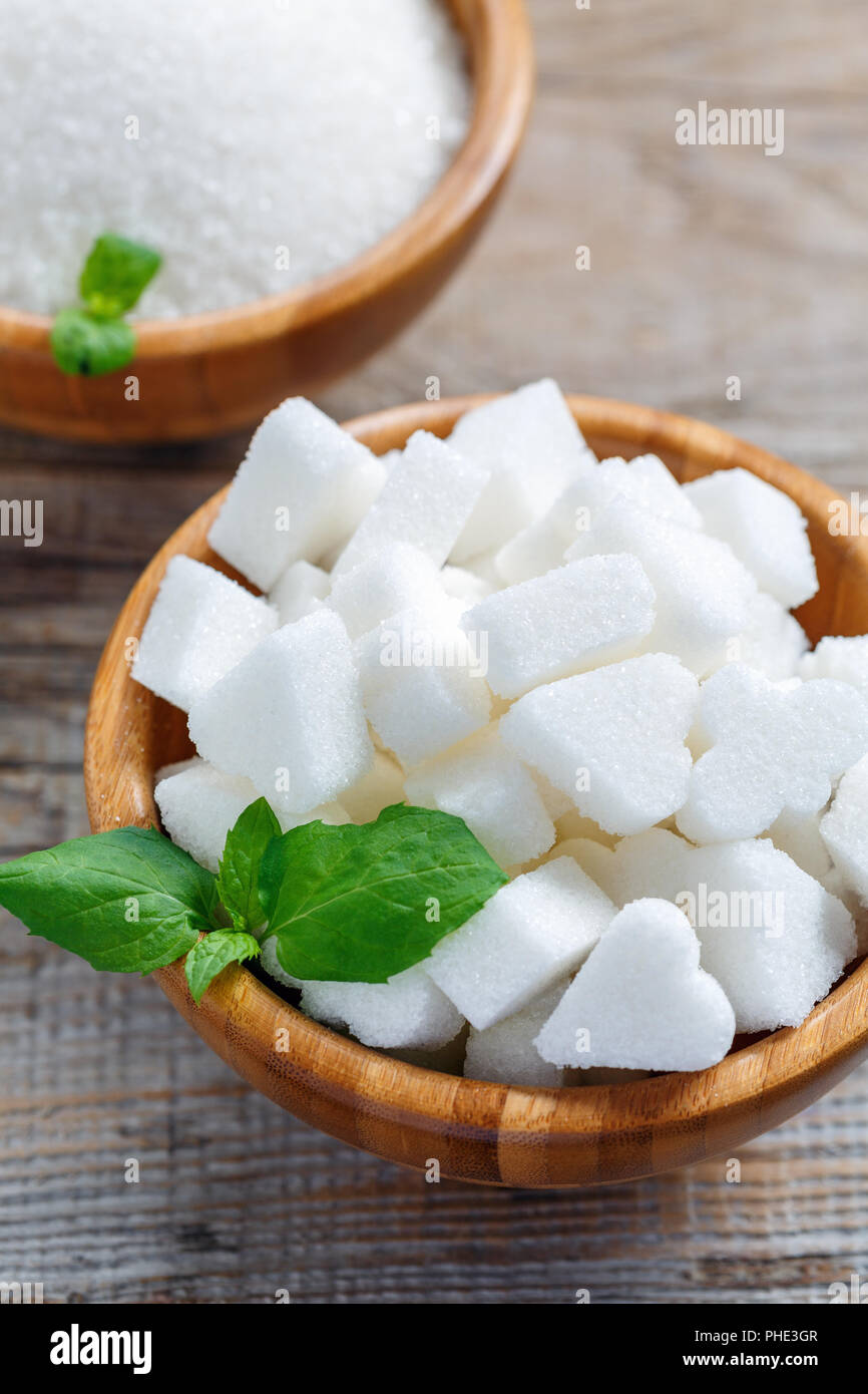 White refined sugar in a wooden bowl. Stock Photo