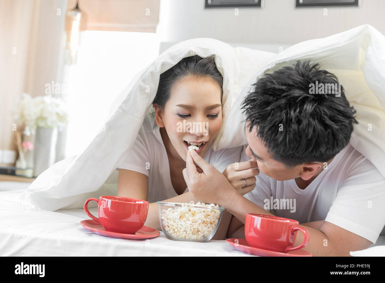 Couples having breakfast on bed Stock Photo Alamy