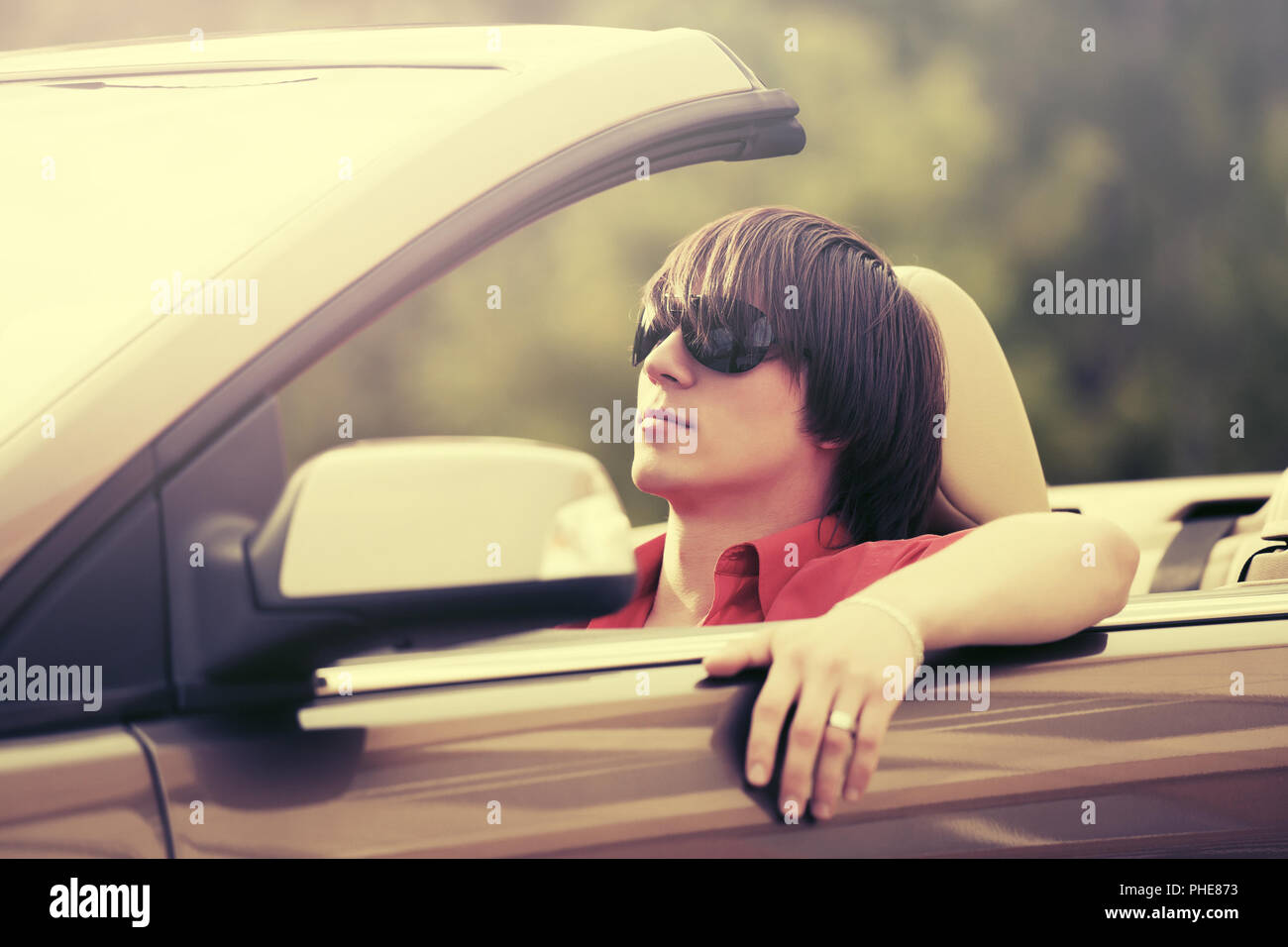 Young man in sunglasses driving convertible car Stock Photo Alamy