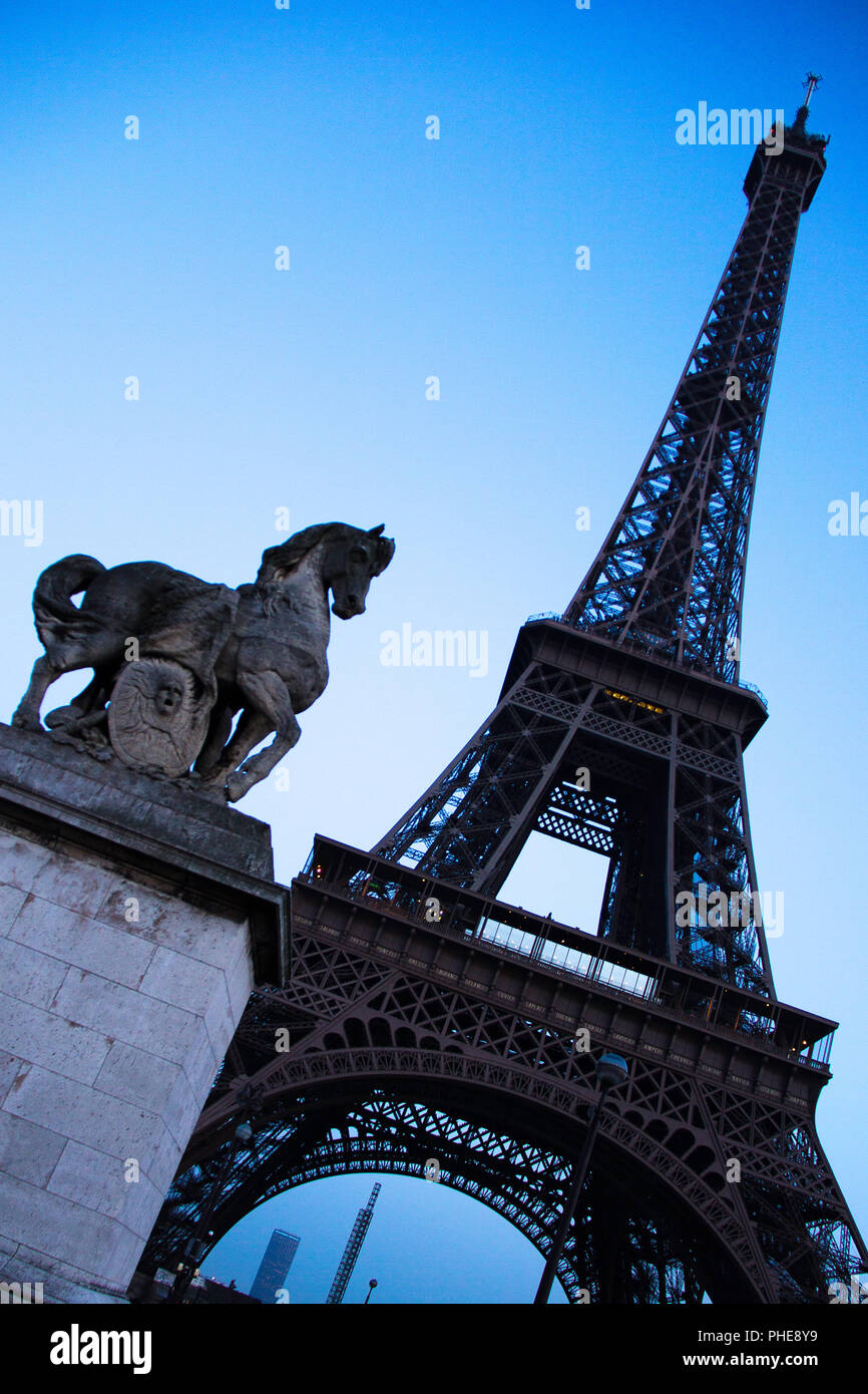 Angled Eiffel Tower with horse statue Stock Photo Alamy