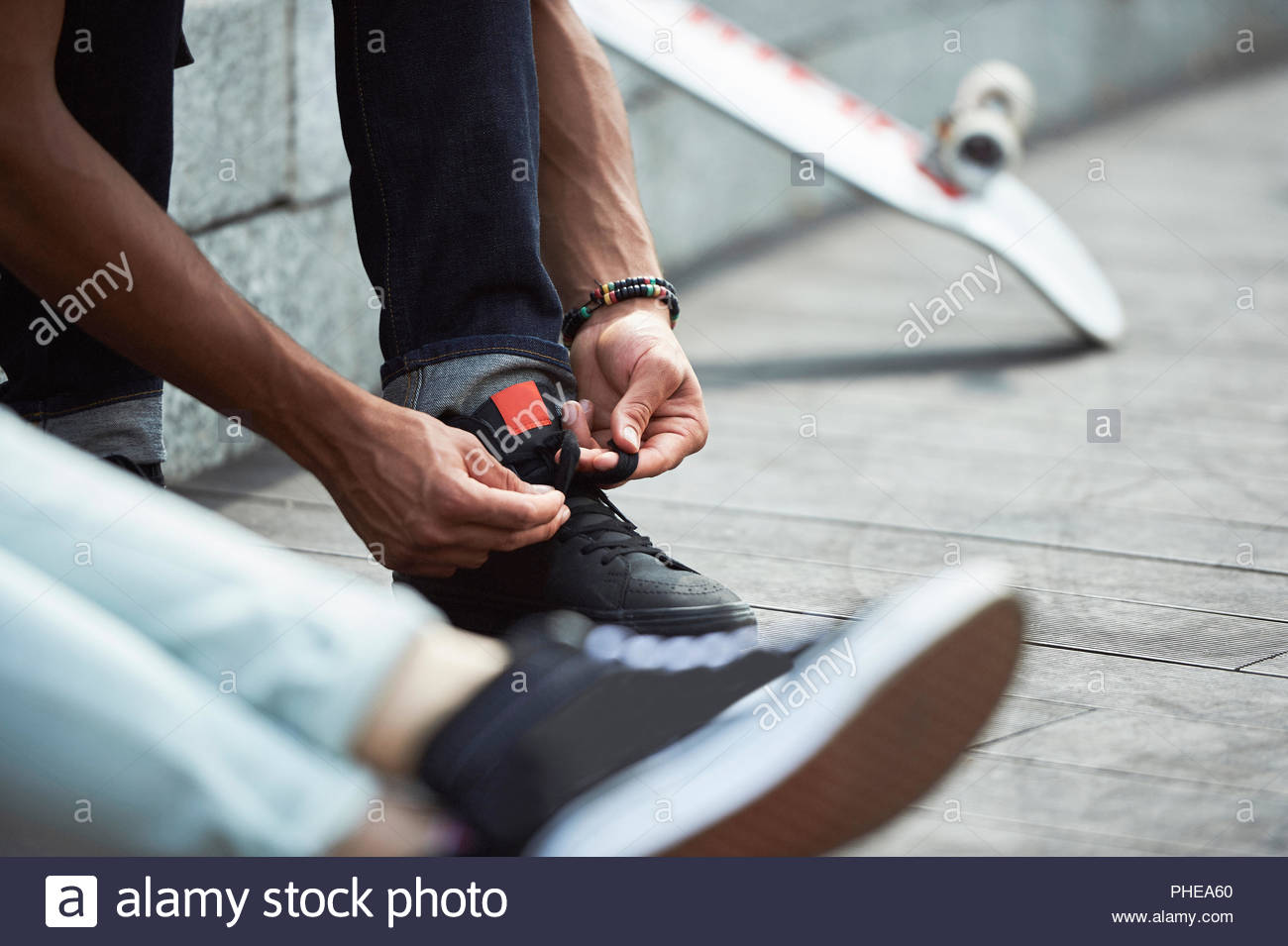 tying his shoelaces