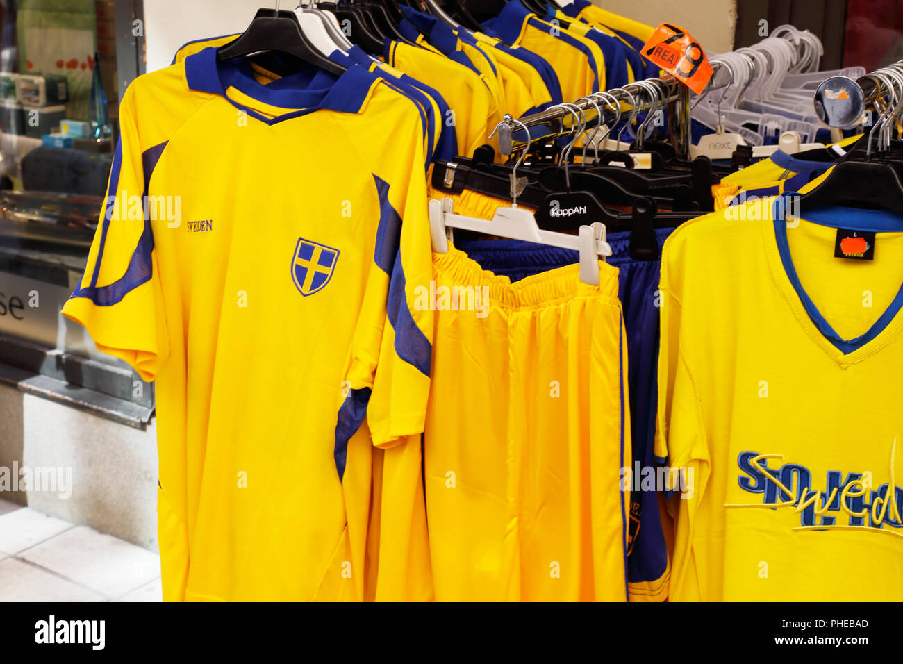Stockholm, Sweden - July 12, 2018: Yellow souvenir football team suporter shirts with Swedish flags for sale at the Drottninggatan street in the downt Stock Photo